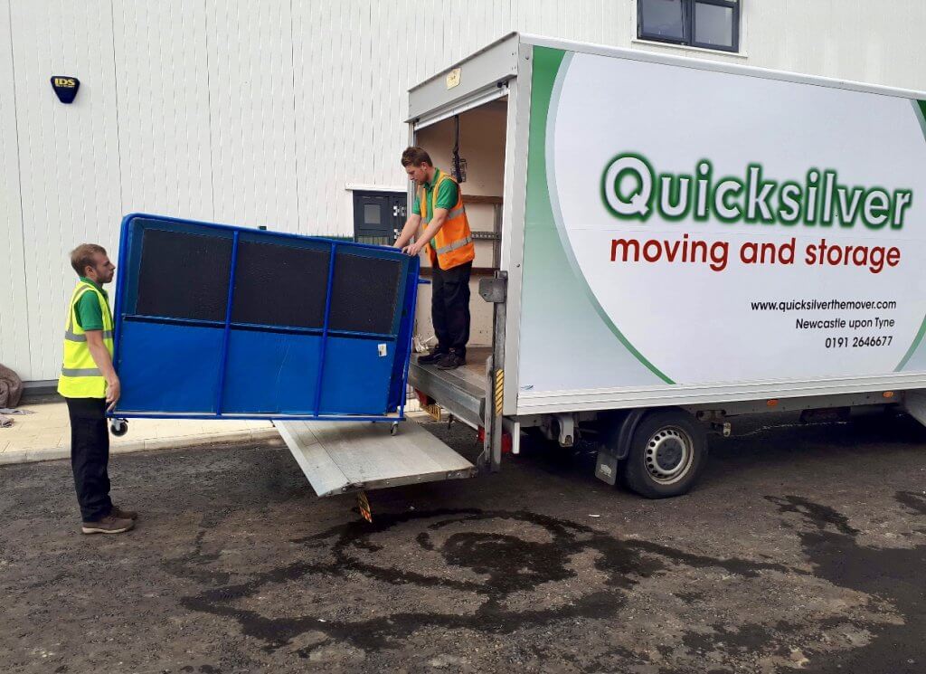 Workers moving item into a small Quicksilver lorry