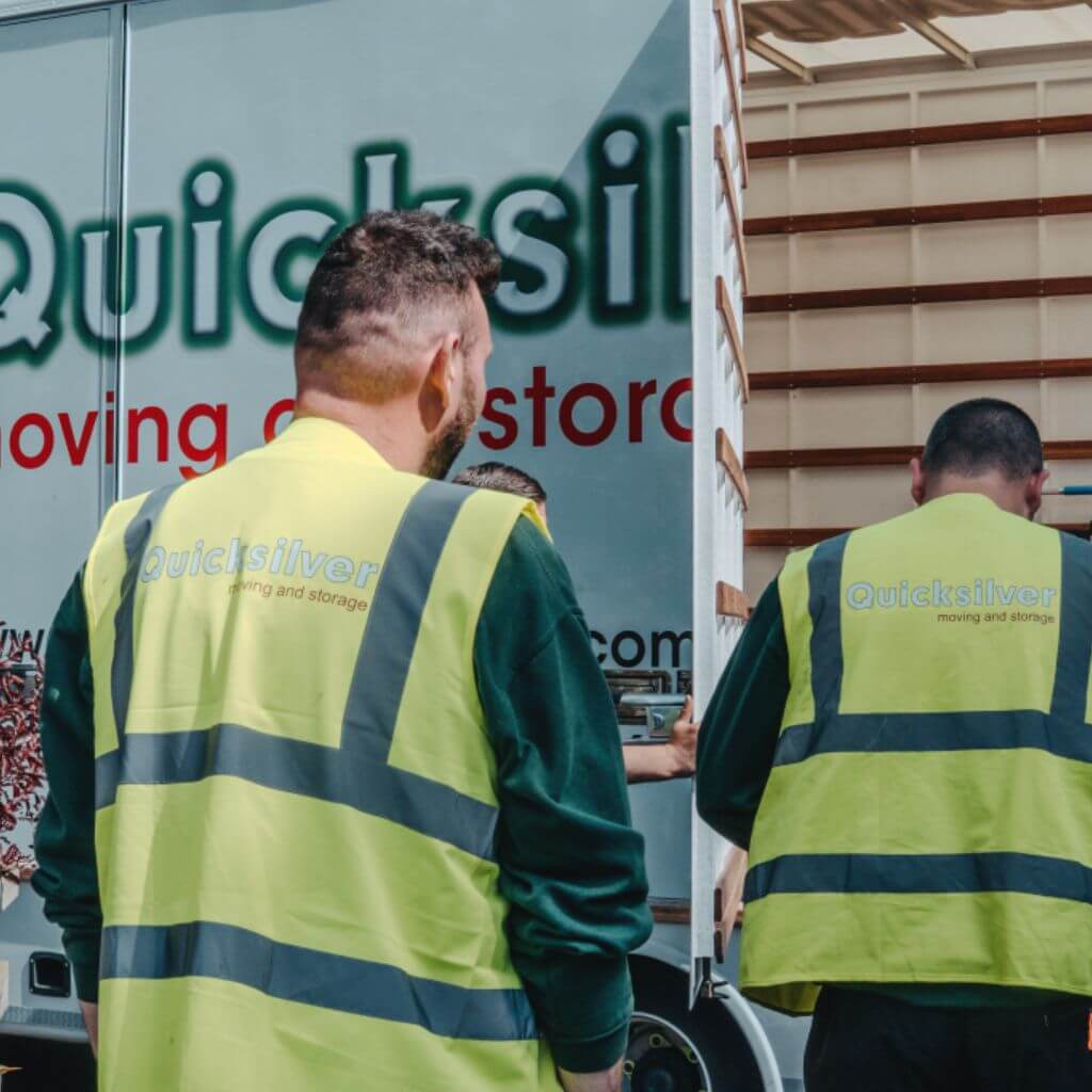 Workers moving item into a small Quicksilver lorry